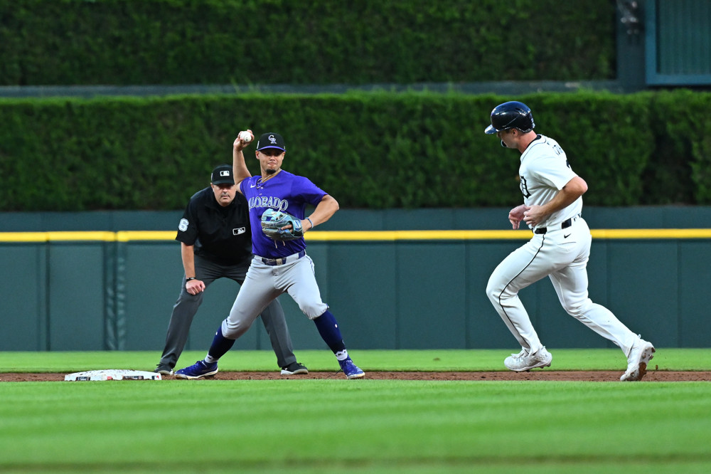 Ezequiel Tovar , right foot on second base, prepares to make a throw to first base to complete a double play.