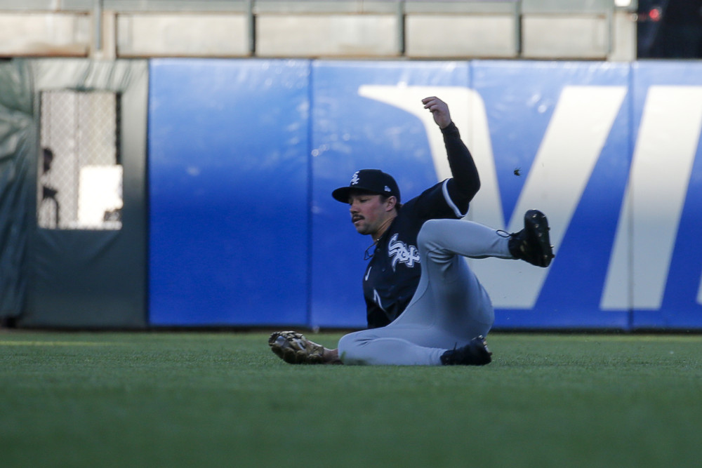 Dominic Fletcher makes a sliding catch, from a sideways sitting position with his left leg up