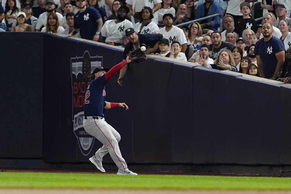 Wilyer Abreu reaches out to make a catch near the right field foul line, not far from the stands at Yankee Stadium