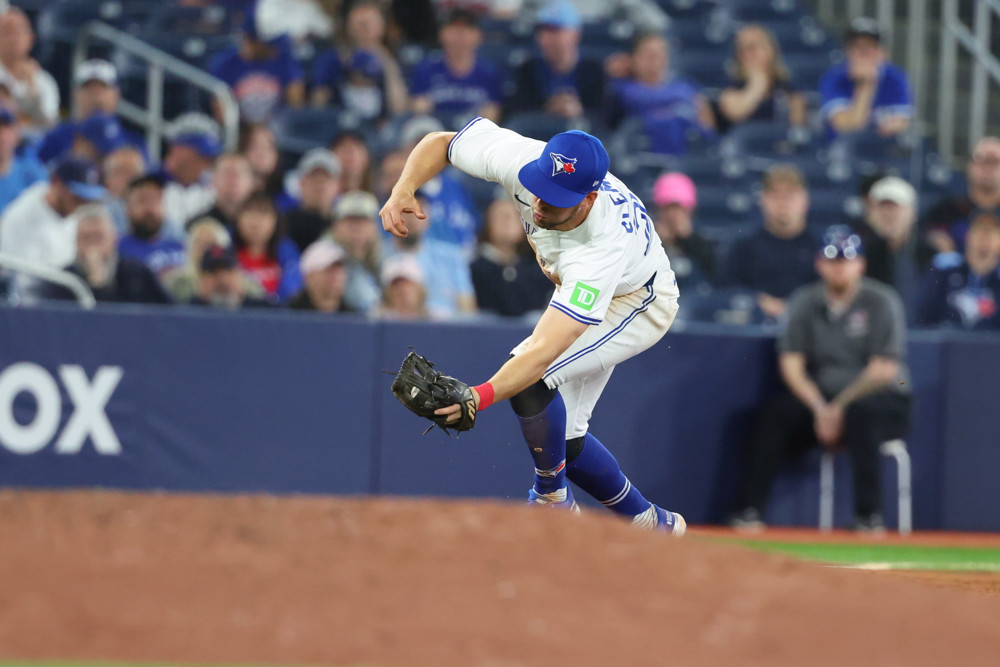 Ernie Clement reaches for a ball at third base.