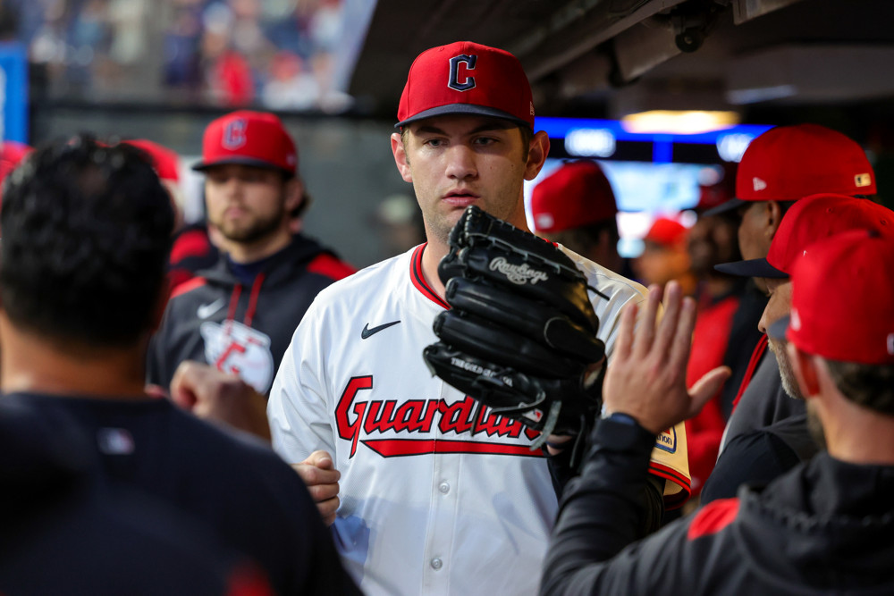 Guardians pitcher Gavin Williams receives congratulations in the dugout from his teammates.